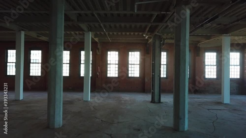 Interior view of an empty, unfinished office space that is under construction inside a large brick building. photo