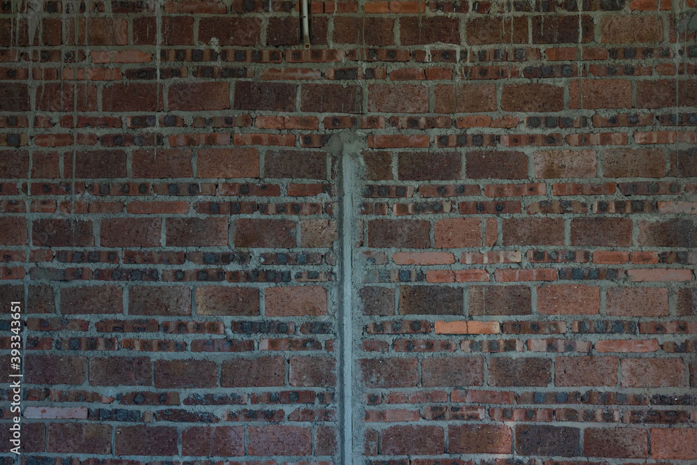 A room in a rough house under construction, with a red brick concrete structure A room in a rough house under construction, with a red brick concrete structure