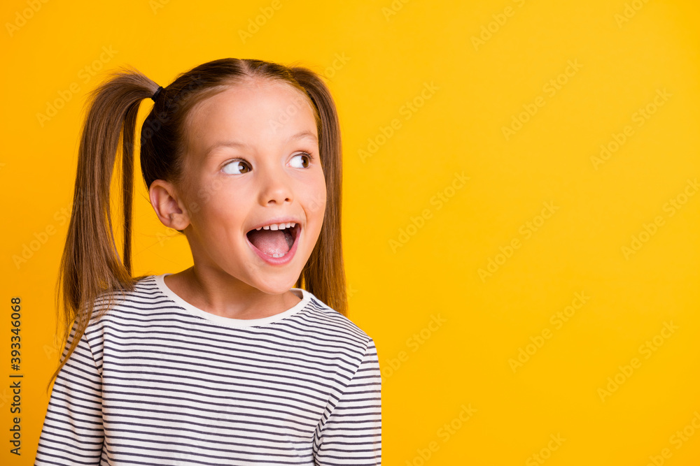 © deagreez - Portrait of happy excited amazed open mouth kid child girl look in copyspace isolated on yellow color background