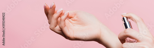 Cuadro en lienzo cropped view of woman holding bottle with luxury perfume isolated on pink, banne