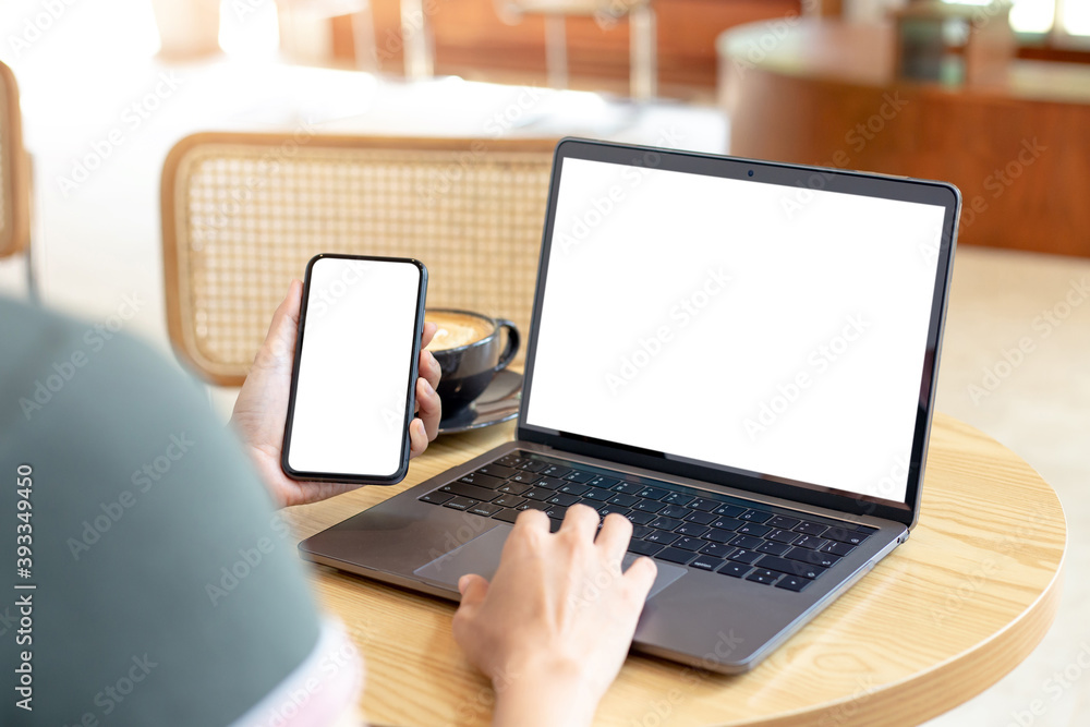 computer,cell phone blank screen mockup.hand woman work using laptop texting mobile. with white background for advertising,contact business search information on desk in cafe.marketing,design computer,cell phone blank screen mockup.hand woman work using laptop texting mobile. with white background for advertising,contact business search information on desk in cafe.marketing,design