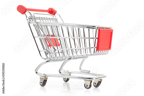 Shiny empty shopping cart with red handle, isolated on white background. © Stockis