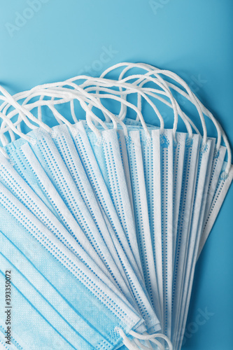 Stack of protective medical masks on a blue background  isolate.