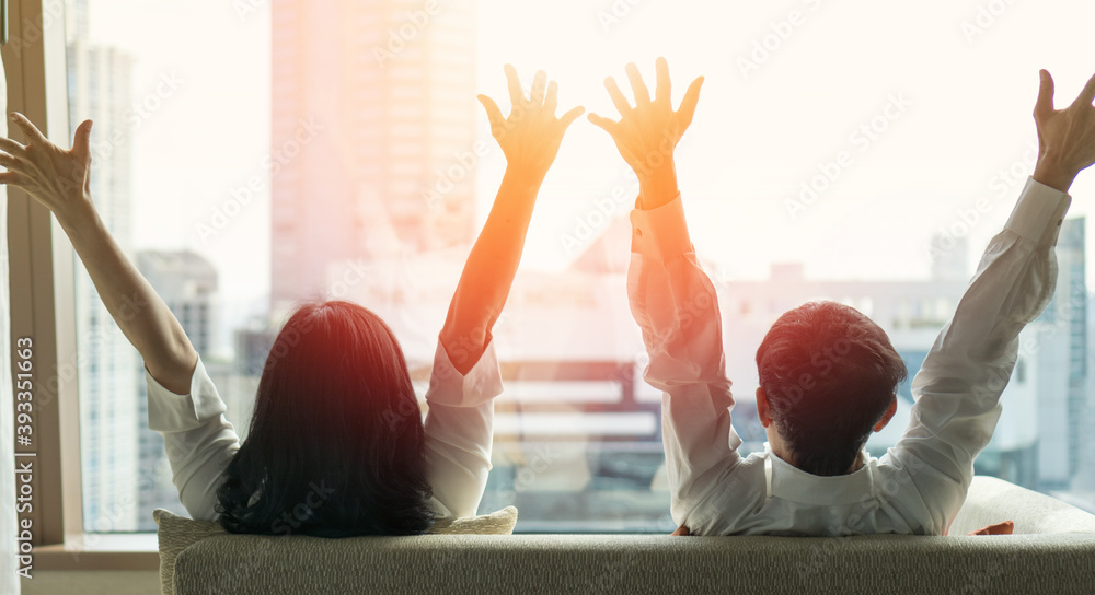 Fototapeta premium Good life and easy relax couple businessman and woman lifestyle after work at hotel sitting hands behind head for happy business people.Simplify Your Life Week