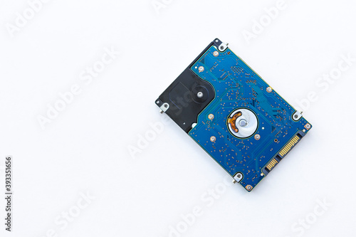 Old hard Disk Drive HDD on White Background, computer data storagedevice for stores and retrieves digital data photo