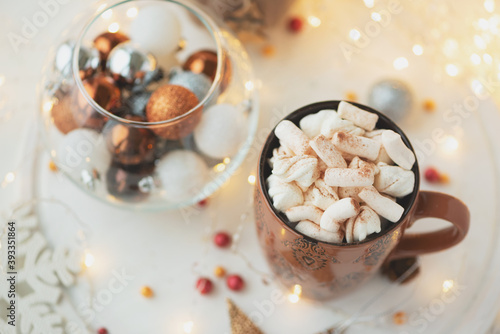 Christmas hot chocolate with marshmallow and gingerbread cookies on white wooden table. Traditional hot drink at Christmas.