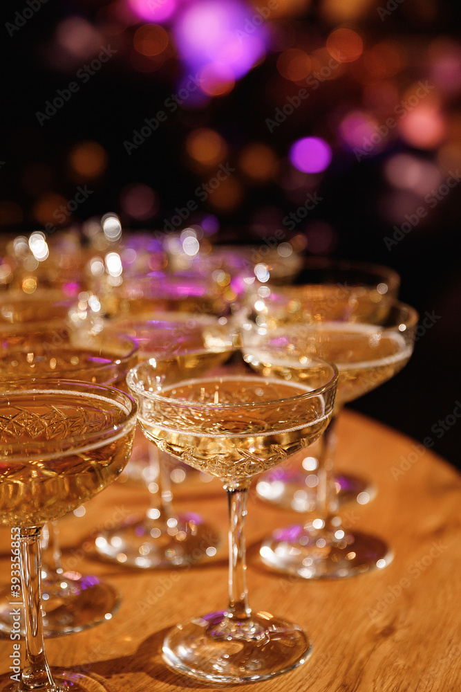 Glasses with Sparkling Wine. champagne glasses over Holiday Bokeh Blinking background. Celebration, party concept. Glasses with Sparkling Wine. champagne glasses over Holiday Bokeh Blinking background. Celebration, party concept.