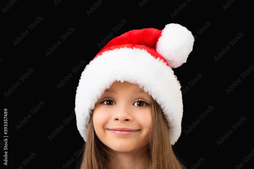 Beautiful little girl in a Christmas hat. Beautiful little girl in a Christmas hat.