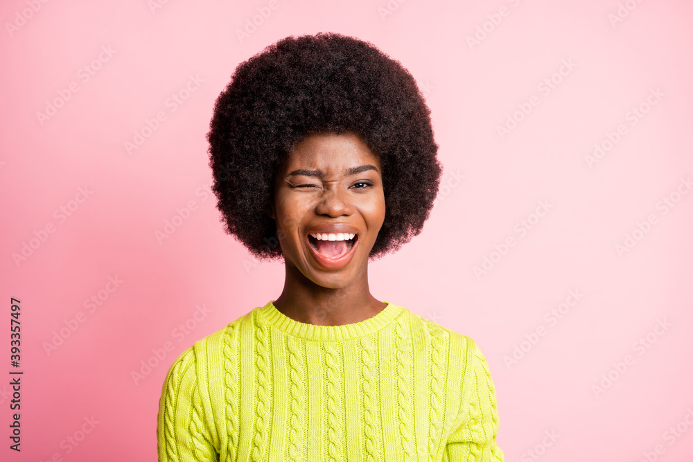 Photo portrait of winking girl isolated on pastel pink colored background Photo portrait of winking girl isolated on pastel pink colored background