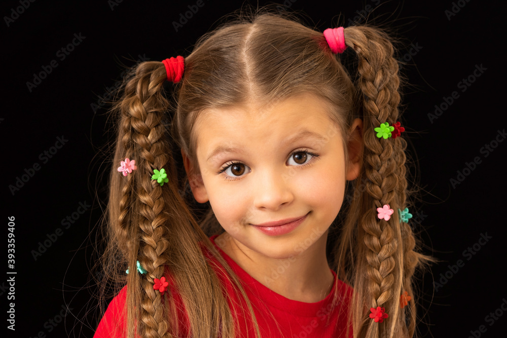 A little girl on a black background smeared with paint. A little girl on a black background smeared with paint.