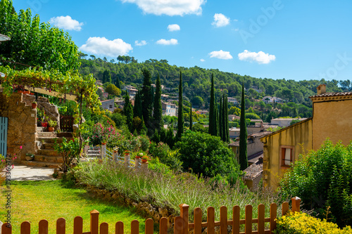 Travel destination, small ancient village Cotignac in Provence, surrounded by vineyards and cliffs with troglodytes houses.