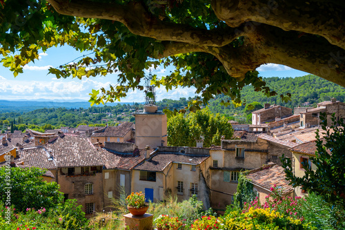 Travel destination, small ancient village Cotignac in Provence, surrounded by vineyards and cliffs with troglodytes houses.