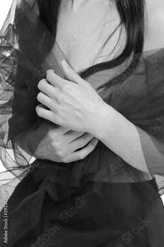 Girl holding a black shawl with her hands