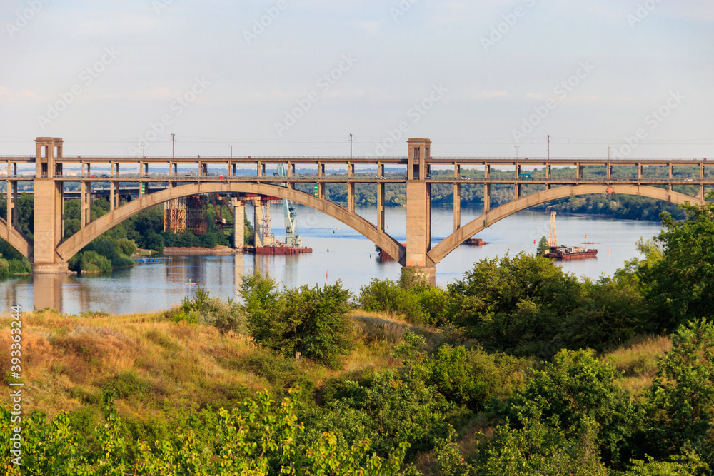 Preobrazhensky bridge over the Dnieper River to Khortytsia island in Zaporizhia, Ukraine Preobrazhensky bridge over the Dnieper River to Khortytsia island in Zaporizhia, Ukraine