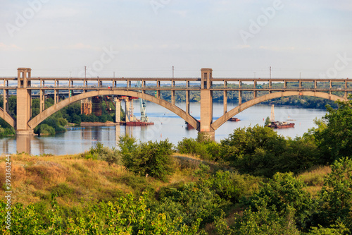 Preobrazhensky bridge over the Dnieper River to Khortytsia island in Zaporizhia, Ukraine © olyasolodenko
