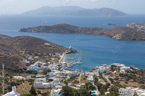 View of the white buildings of Chora and port, Ios island, Greece.
