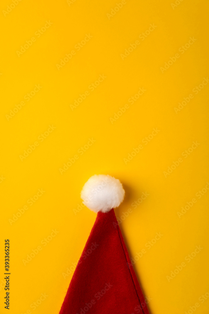 Christmas modern composition. Santa hat on yellow background. Flat lay, top view, copy space. Christmas modern composition. Santa hat on yellow background. Flat lay, top view, copy space.
