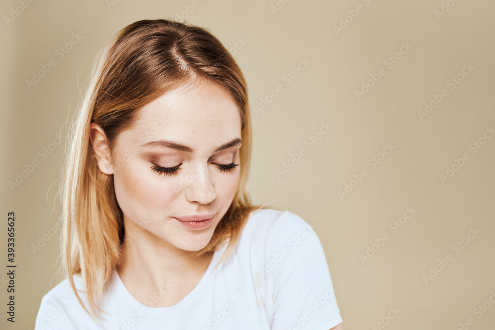 Cheerful blonde gesturing with her hands studio beige background Cheerful blonde gesturing with her hands studio beige background