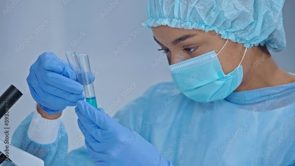 African american scientist looking at test tube with sample African american scientist looking at test tube with sample