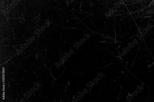 Black film with scratches. Abstract background.