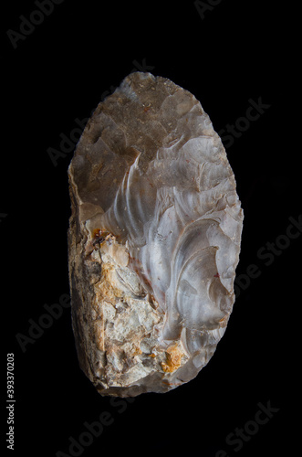 bifacial backed knife. Knife carved in flint from the Middle Paleolithic, on black background photo