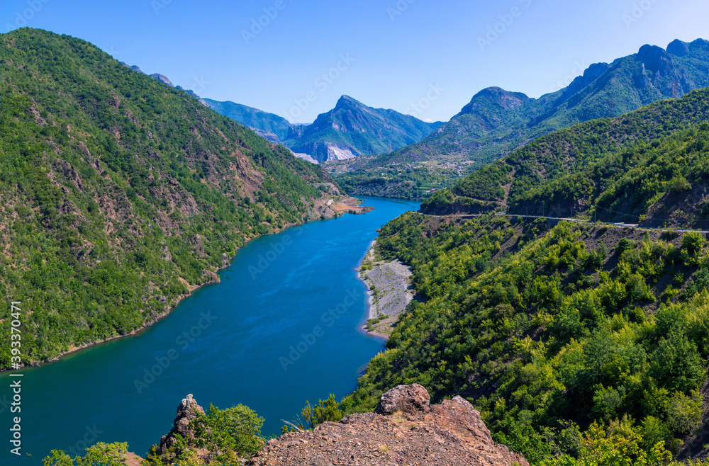 Beautiful summer landscape with blue river in Albanian mountains, covered with lush foliage