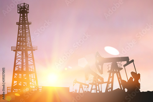 Darck silhoutte of oil rig and pumps during sunset.
