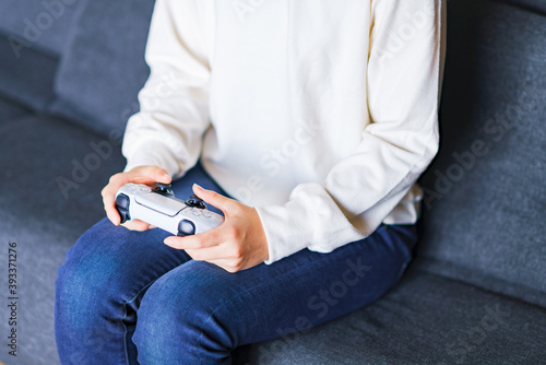 Lifestyle of Japanese girl playing game by using wireless controller  © show999