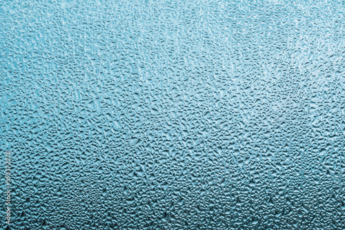 Water condensation, Water drops, Water droplets on glass window, Dew drops in light blue background, 
