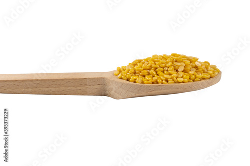 Mung dal or Mung daal bean on wooden spoon. nutrition. bio. natural food ingredient.