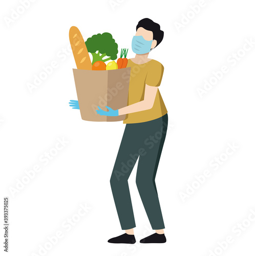 Courier in mask and gloves delivers grocery products. Contactless delivery during coronavirus.