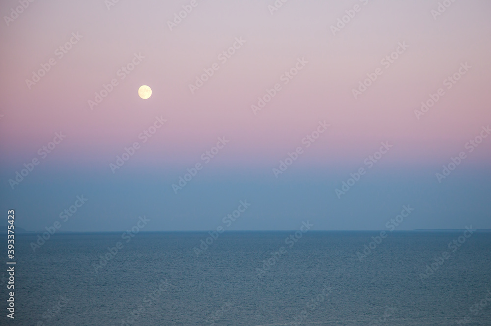 a moon over the sea
