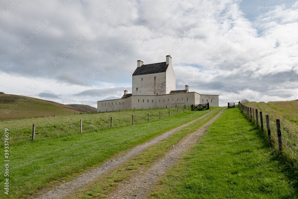 Landscape with white Corgarff Castle in Socttish landscape at sunny afternoon Landscape with white Corgarff Castle in Socttish landscape at sunny afternoon