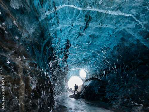 A man in an Ice Cave in Breiðarmerkurjökull Outlet Glacier, Vatnajökull National Park, Southeast Iceland.