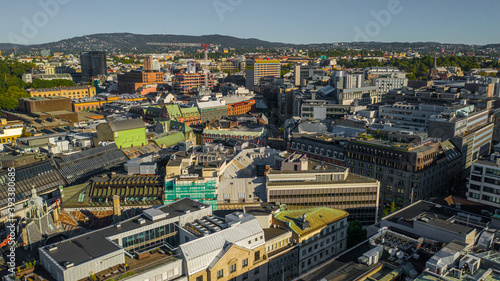 Fototapeta Naklejka Na Ścianę i Meble -  Oslo, Norway. Beautiful panoramic aerial view photo from flying drone for Oslo city center. Against the background of the sea, mountains and blue sky on a sunny summer day. (Series)