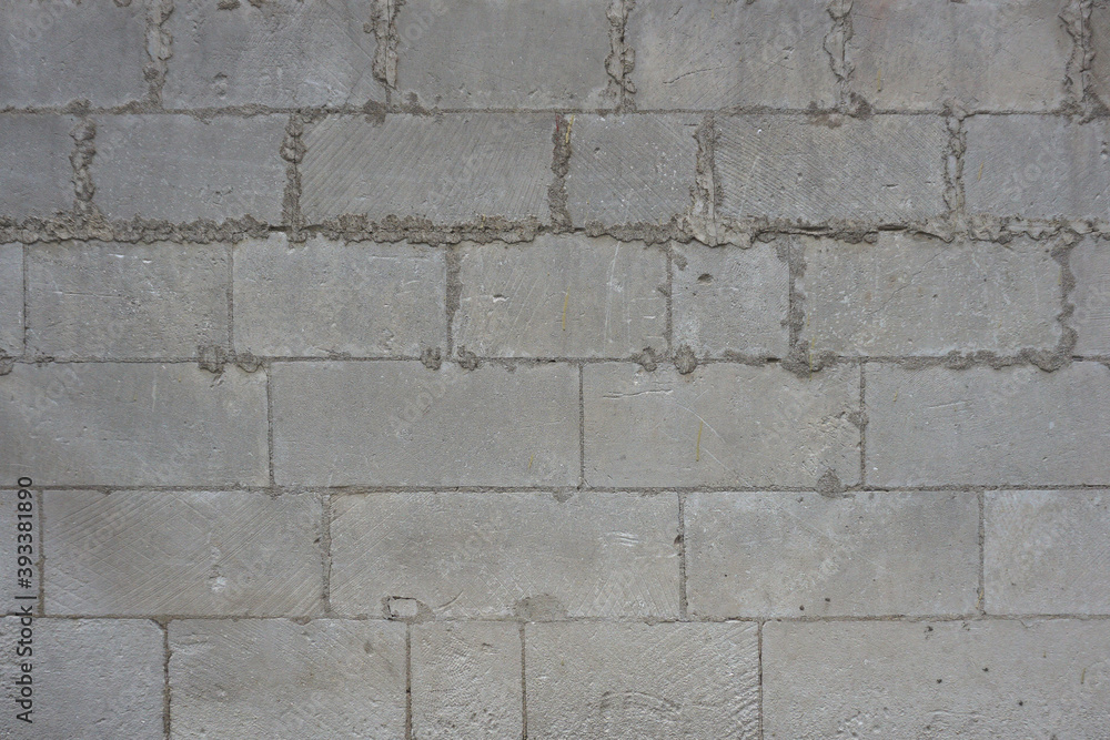 A wall of gray rectangular blocks. Texture for background. A wall of gray rectangular blocks. Texture for background.