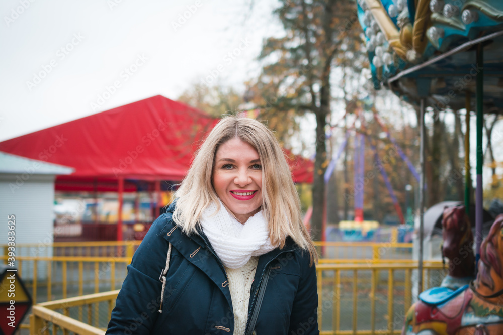 A beautiful girl is photographed in the autumn on the street