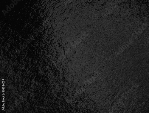 Black foil background with highlights and uneven texture