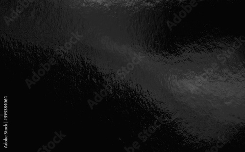 Black foil background with highlights and uneven texture photo