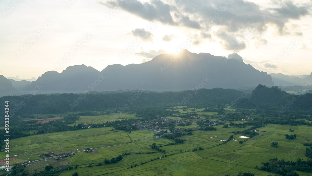 Beautiful Sunset Views of Mountainous in Vang Vieng City which Popular for Tourists. View of Rice Fields Under the Mountains.