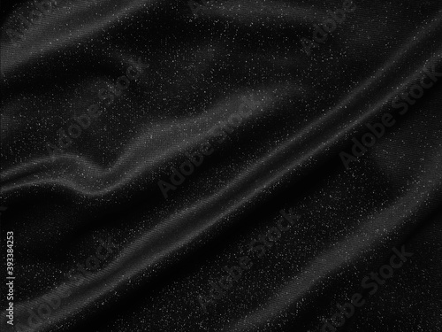 Shiny black crumpled fabric texture. Elegant cloth background