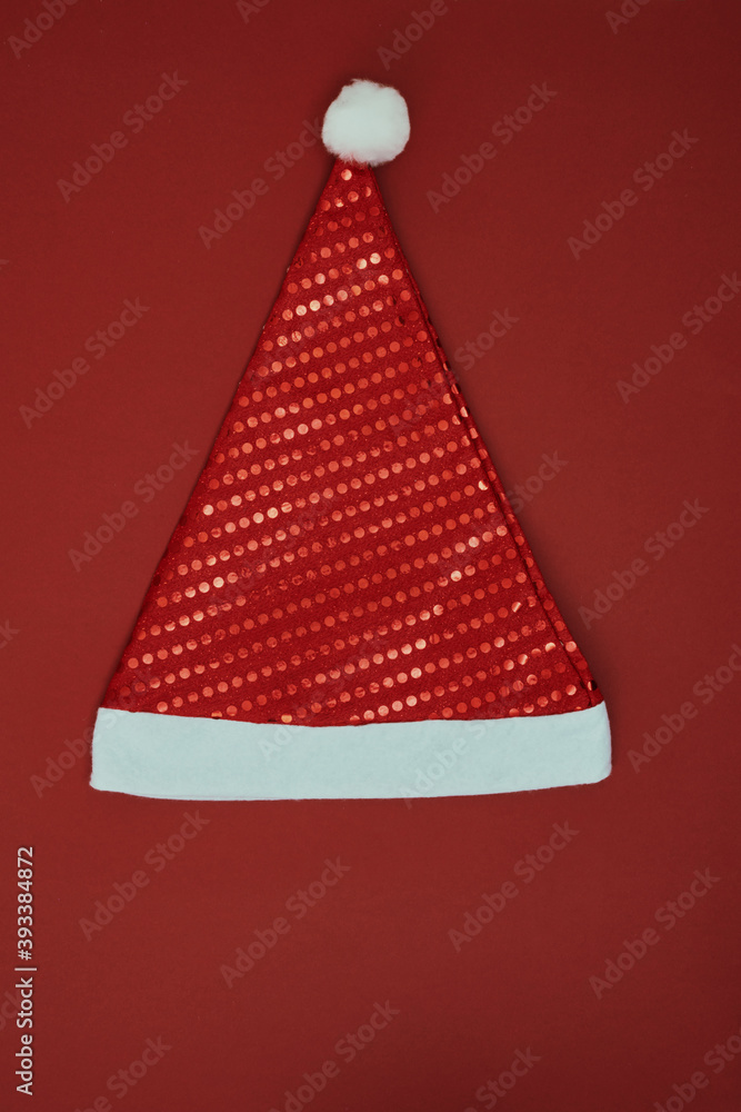 Christmas hat on a red background. New Year's decor. Copy space, mock up. Christmas hat on a red background. New Year's decor. Copy space, mock up.