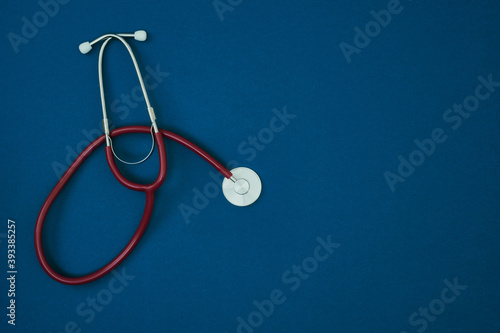 Stethoscope on a blue background. Christmas and New Year's pandemic. Copy space, mock up