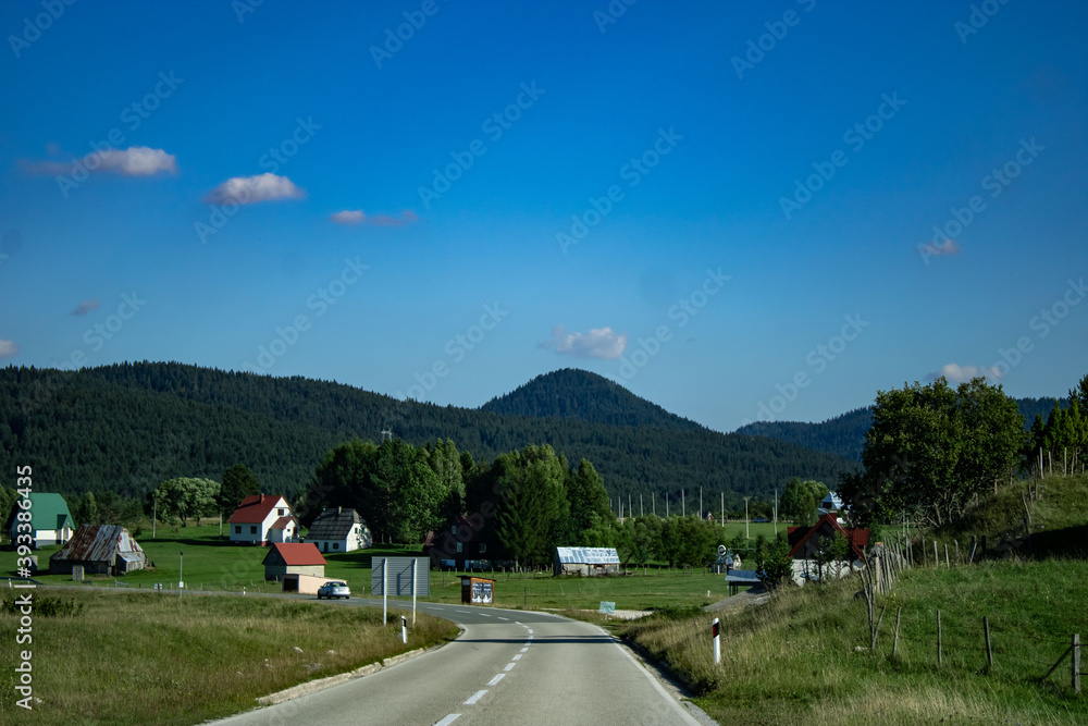 Small village in the hills. Picturesque mountain landscape of Durmitor National Park, Montenegro, Europe, Balkans, Dinaric Alps, UNESCO World Heritage Site.