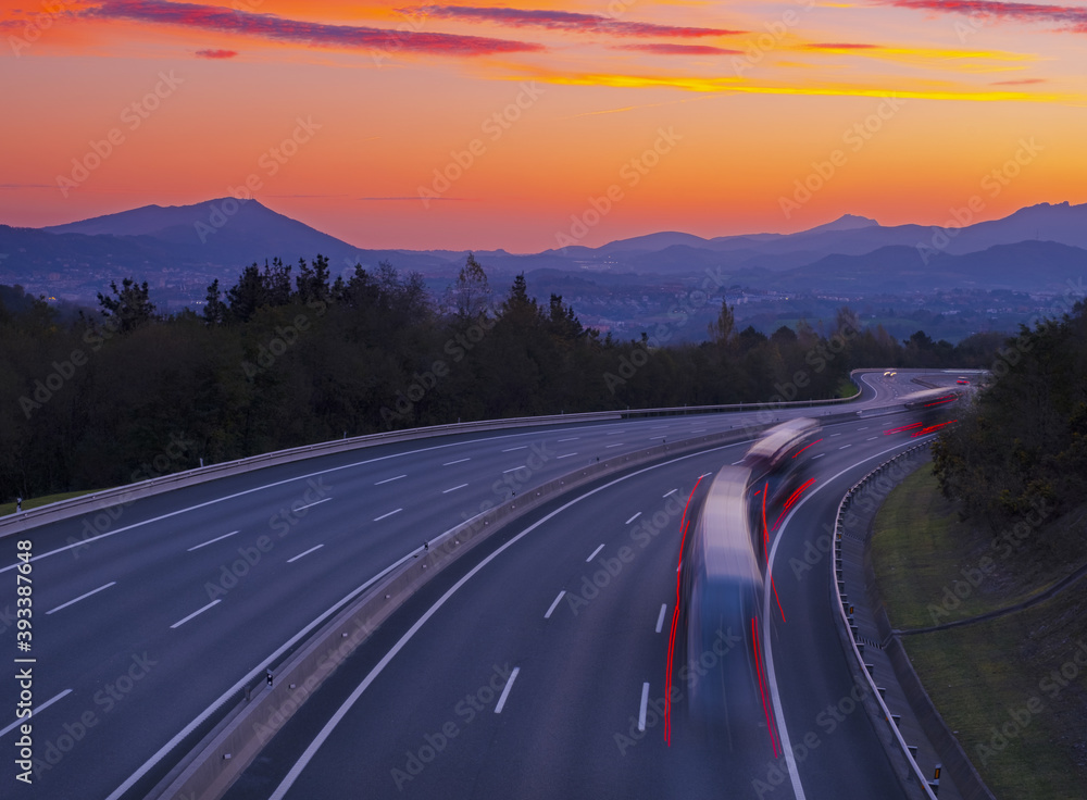 Truck traffic on the A8 motorway at dawn, city of Donostia, Euskadi