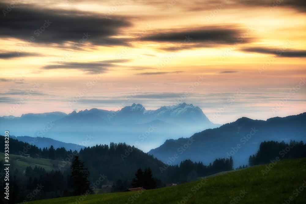 Sunset over Mount Saentis in Swiss Alps with Bregenzerwald, Austria, Vorarlberg, in foreground