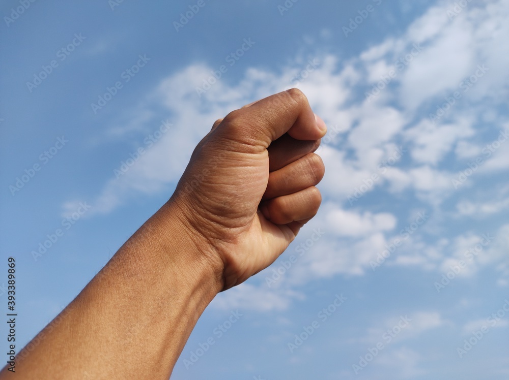 Original picture of fist on sky background Original picture of fist on sky background