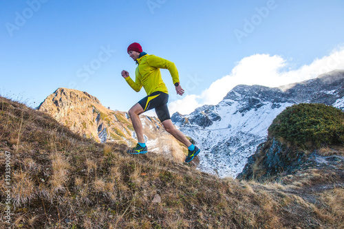 Young man is doing a jogging workout in the mountains.