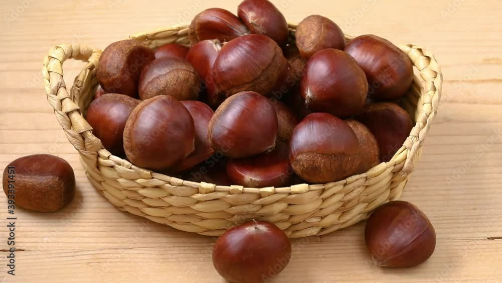 Group of sweet chestnuts in a basket close up Group of sweet chestnuts in a basket close up