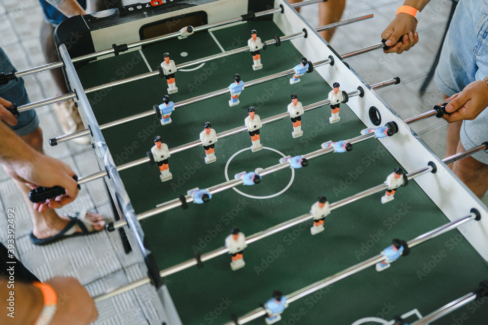 Fototapeta premium guys are playing table football view from above. table football soccer with white and blue players